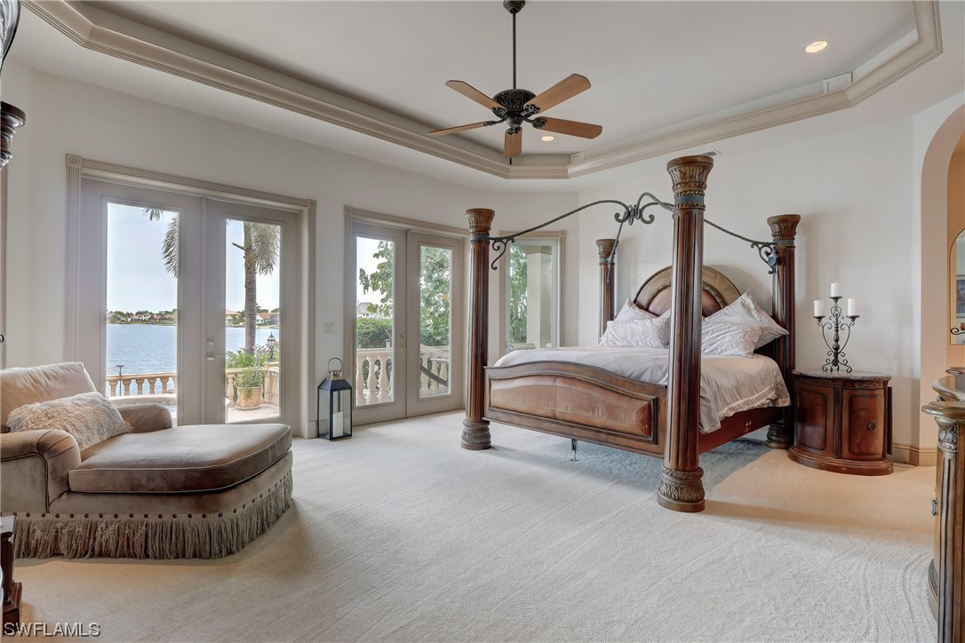 5960 Harborage Drive Fort Myers, FL 33908 - Photo 7 of 32 a spacious bedroom with a bed a ceiling fan and a large window