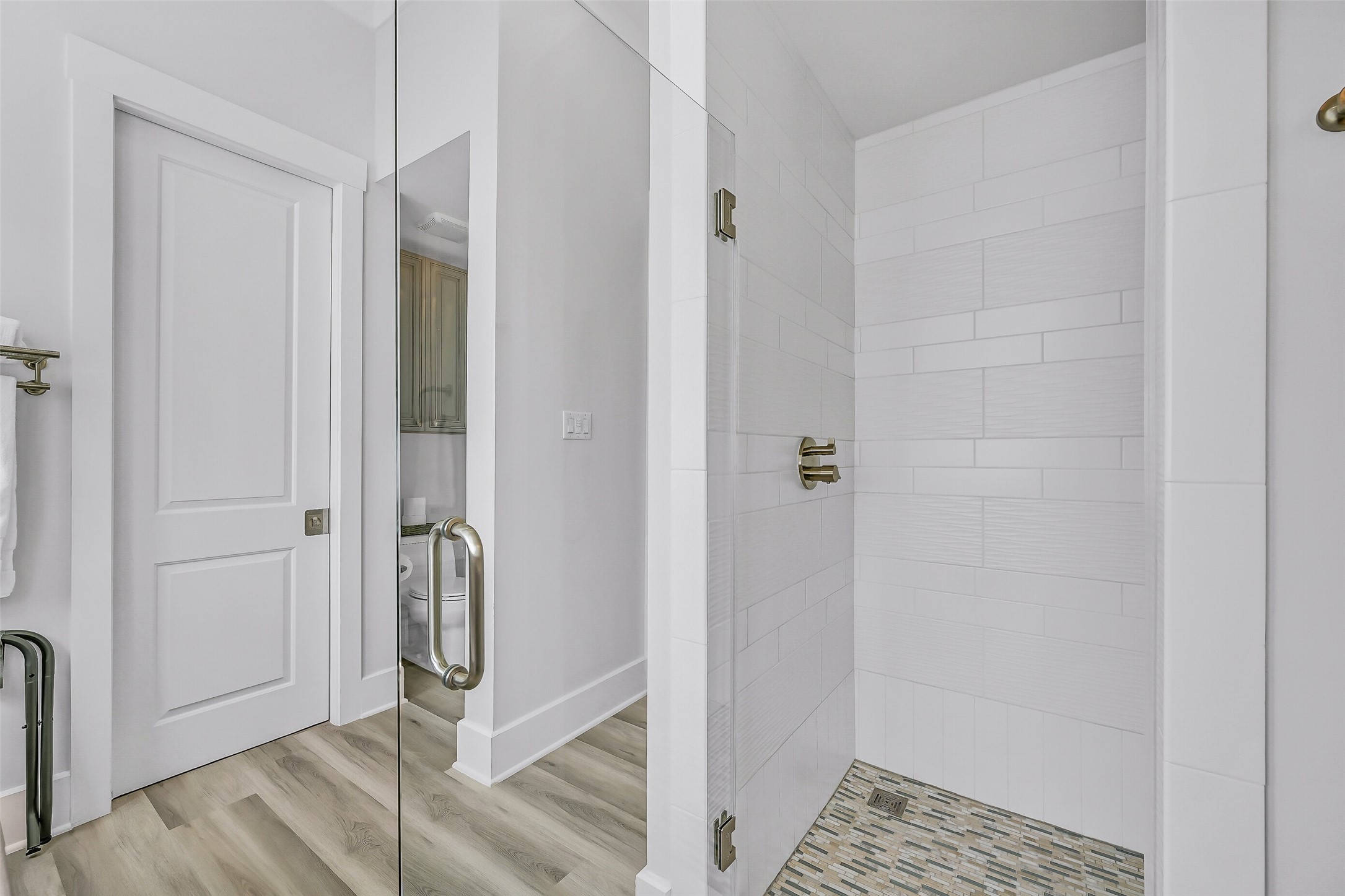 817 Positano Road Galveston, TX 77550 - Photo 31 of 50 Frameless glass and designer tile create a sophisticated shower experience that feels straight from a luxury resort. Beautifully finished and easy to maintain, this space blends functionality with refined coastal elegance.