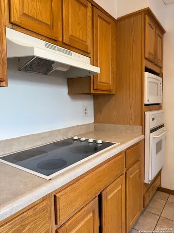 a kitchen with granite countertop cabinets stainless steel appliances and a sink