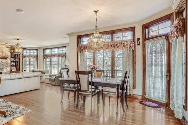 a living room with furniture fireplace and a large window