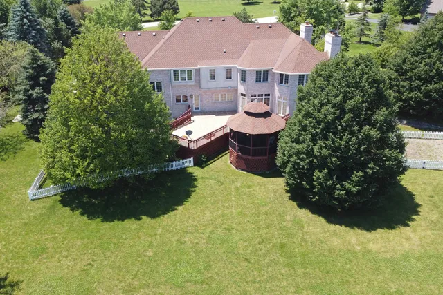 a view of a house with a yard and garden