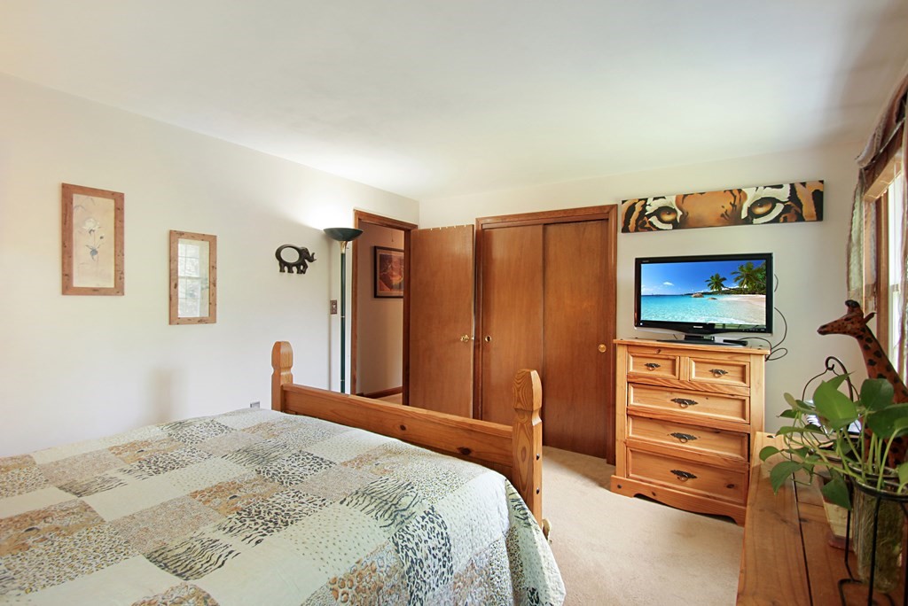 12 Indian Rock Road Haverhill, MA 01832 - Photo 12 of 31 a bedroom with a bed and a flat screen tv