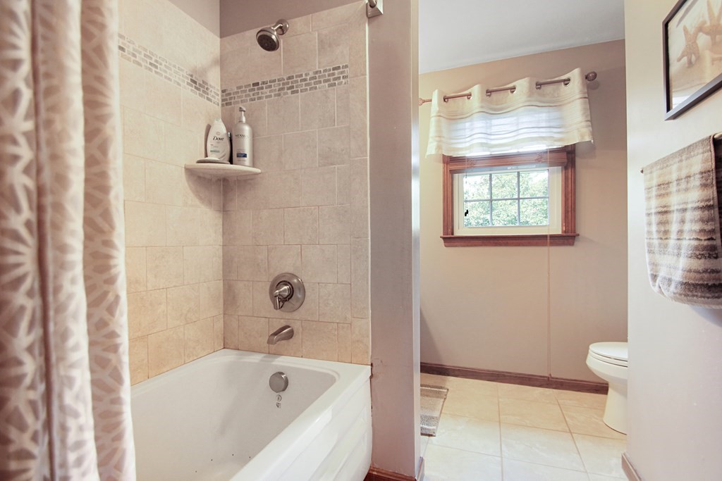 12 Indian Rock Road Haverhill, MA 01832 - Photo 17 of 31 a bathroom with a bathtub a window and a shower