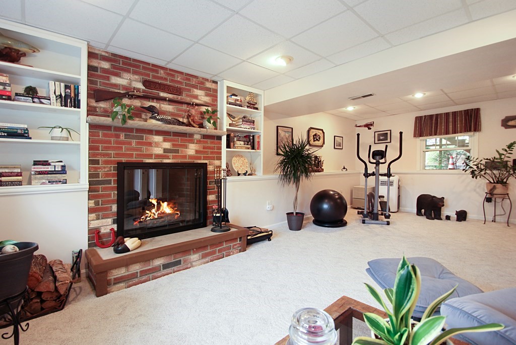 12 Indian Rock Road Haverhill, MA 01832 - Photo 19 of 31 a living room with furniture and a fireplace