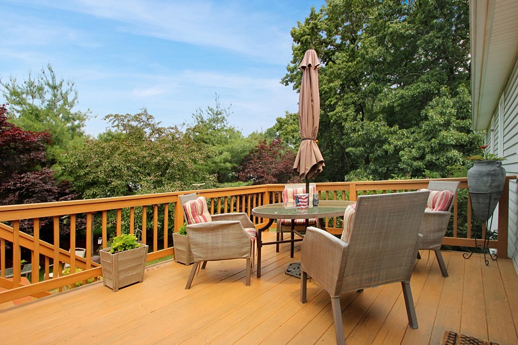 12 Indian Rock Road Haverhill, MA 01832 - Photo 25 of 31 a roof deck with table and chairs and potted plants with wooden floor and fence