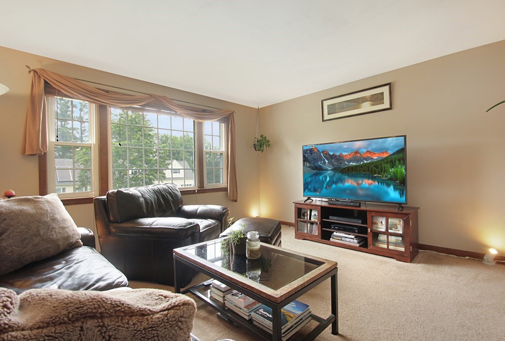 12 Indian Rock Road Haverhill, MA 01832 - Photo 4 of 31 a living room with furniture and a flat screen tv
