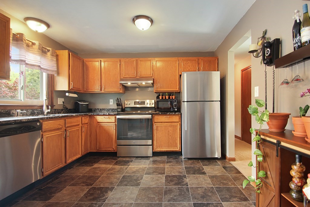 12 Indian Rock Road Haverhill, MA 01832 - Photo 6 of 31 a kitchen with a refrigerator and a sink