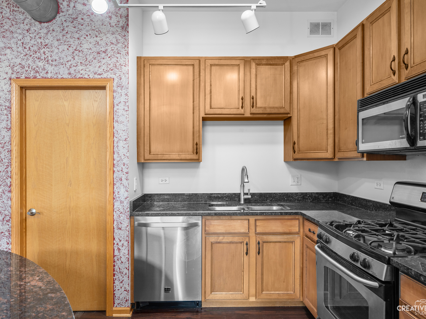 1716 Simms Street Aurora, IL 60504 - Photo 8 of 29 a kitchen with stainless steel appliances granite countertop a stove a sink and a microwave