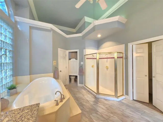 a spacious bathroom with a tub and shower