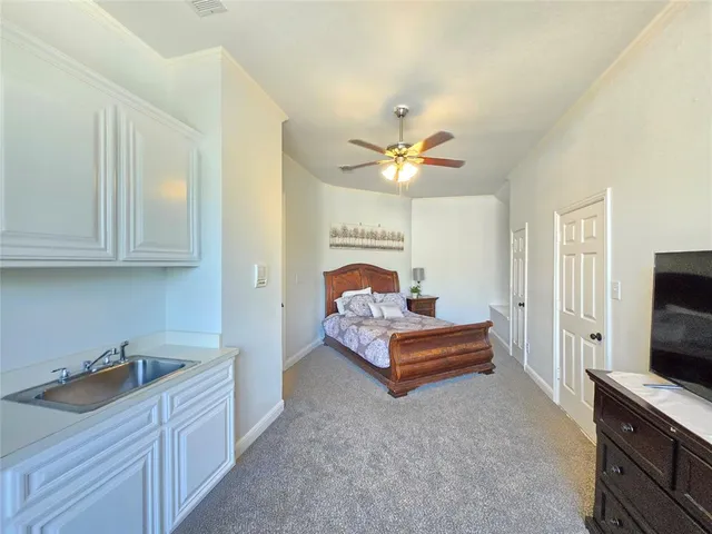 a bedroom with furniture and a flat screen tv