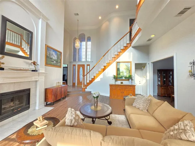 a living room with furniture a fireplace and a large mirror