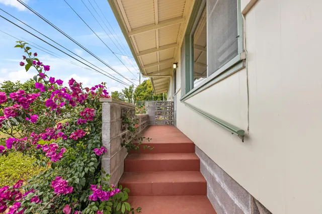 a view of an empty room with closet and a window
