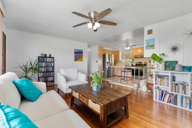 a living room with furniture and a book shelf