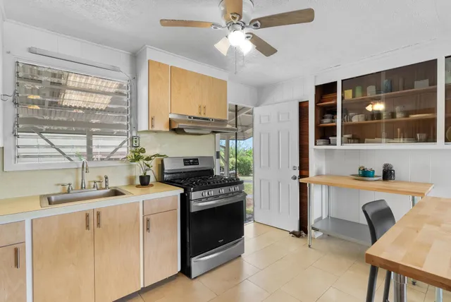 a kitchen with a stove a sink and a refrigerator