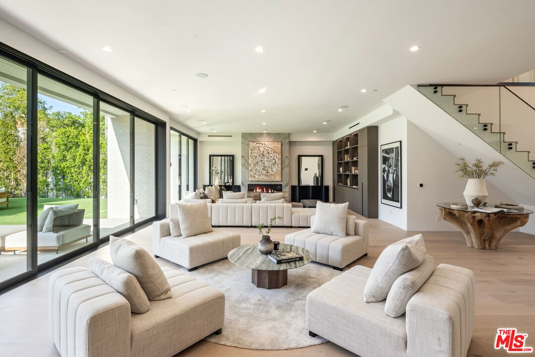 17055 Rancho Street Encino, CA 91316 - Photo 38 of 73 a living room with furniture and large windows