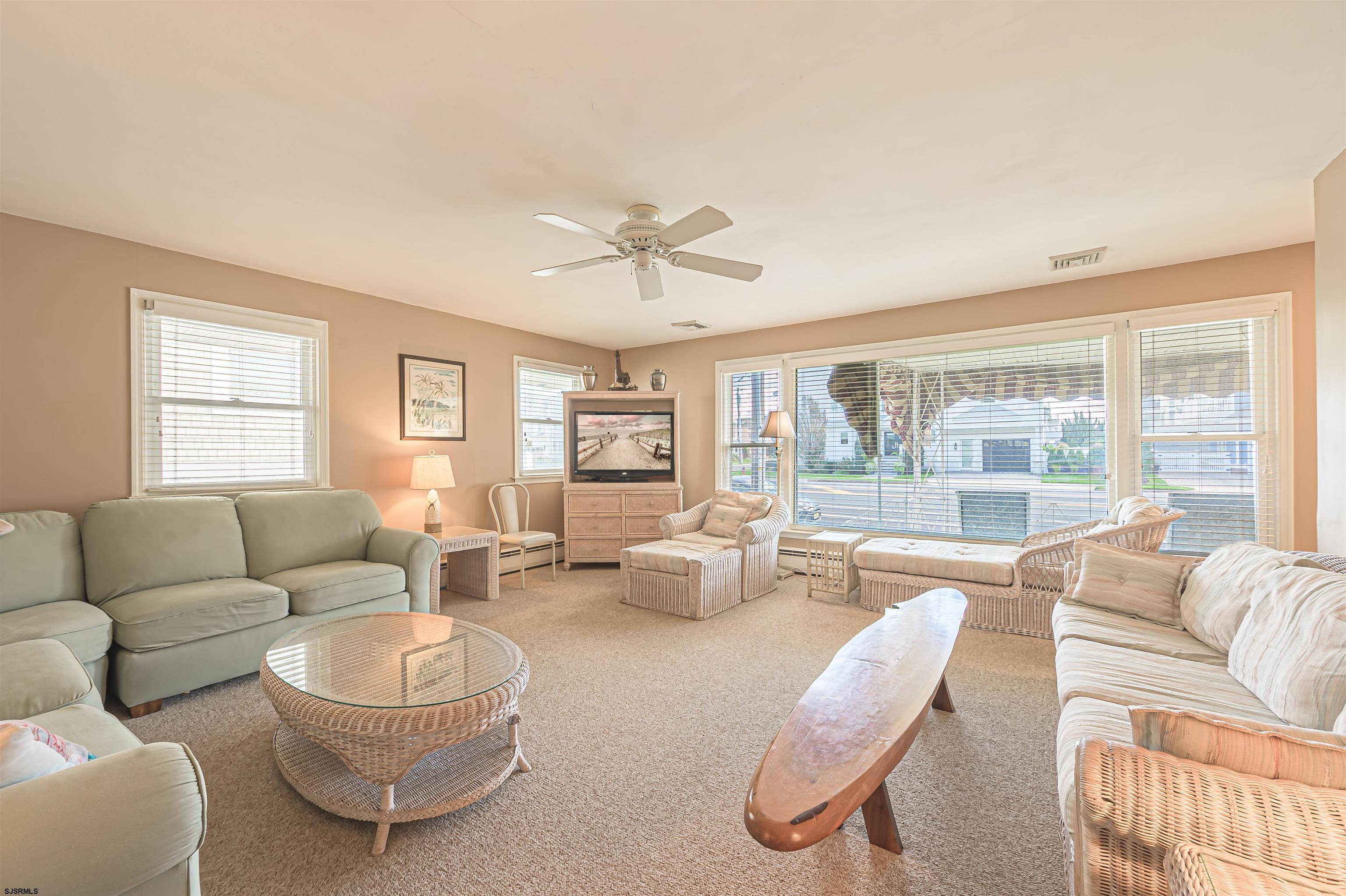 2805 Atlantic Avenue, Unit IDEAL LOCATION Longport, NJ 08403 - Photo 12 of 26 a living room with furniture and a large window with balcony view
