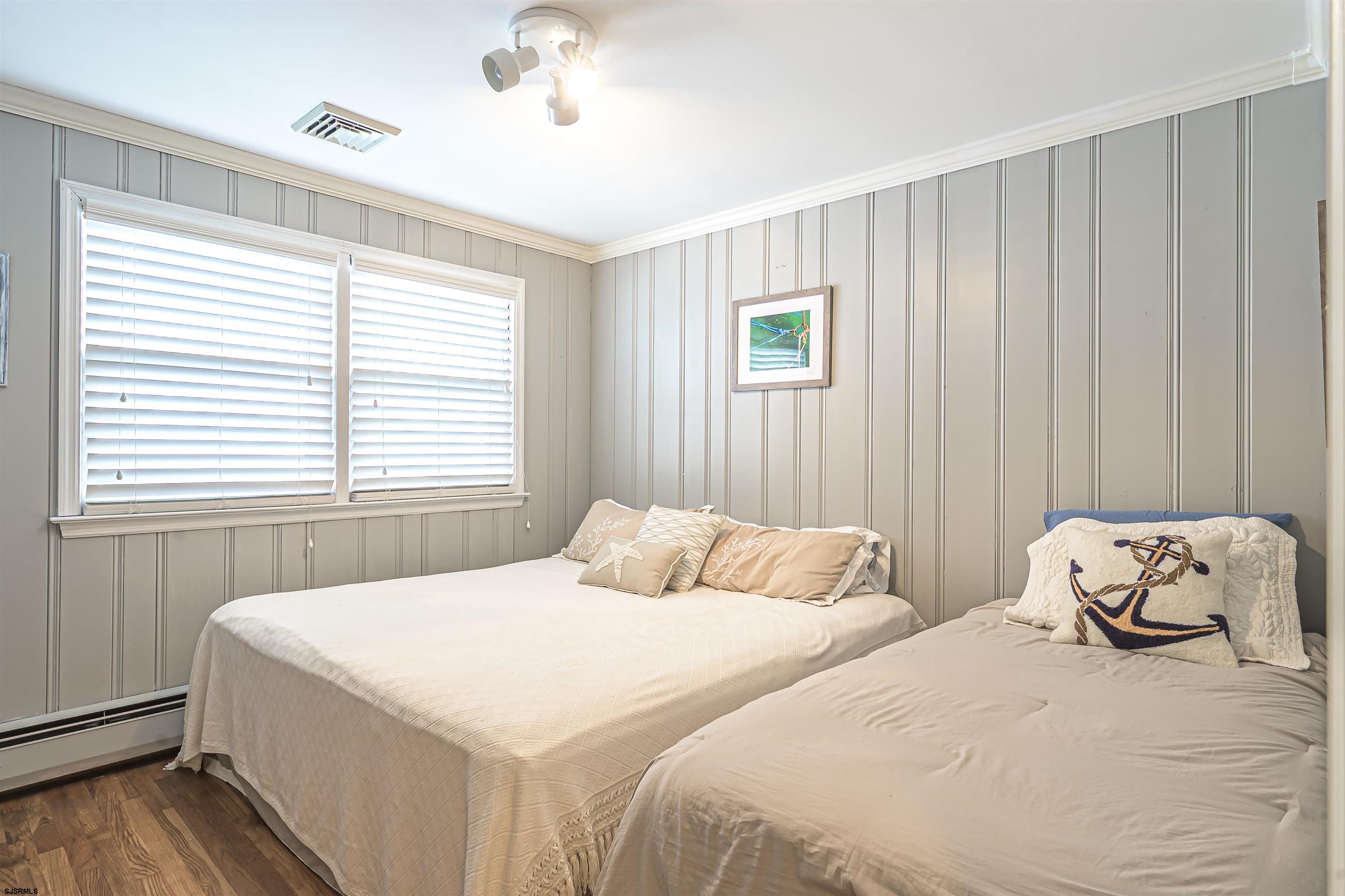 2805 Atlantic Avenue, Unit IDEAL LOCATION Longport, NJ 08403 - Photo 20 of 26 a bedroom with two beds and a window