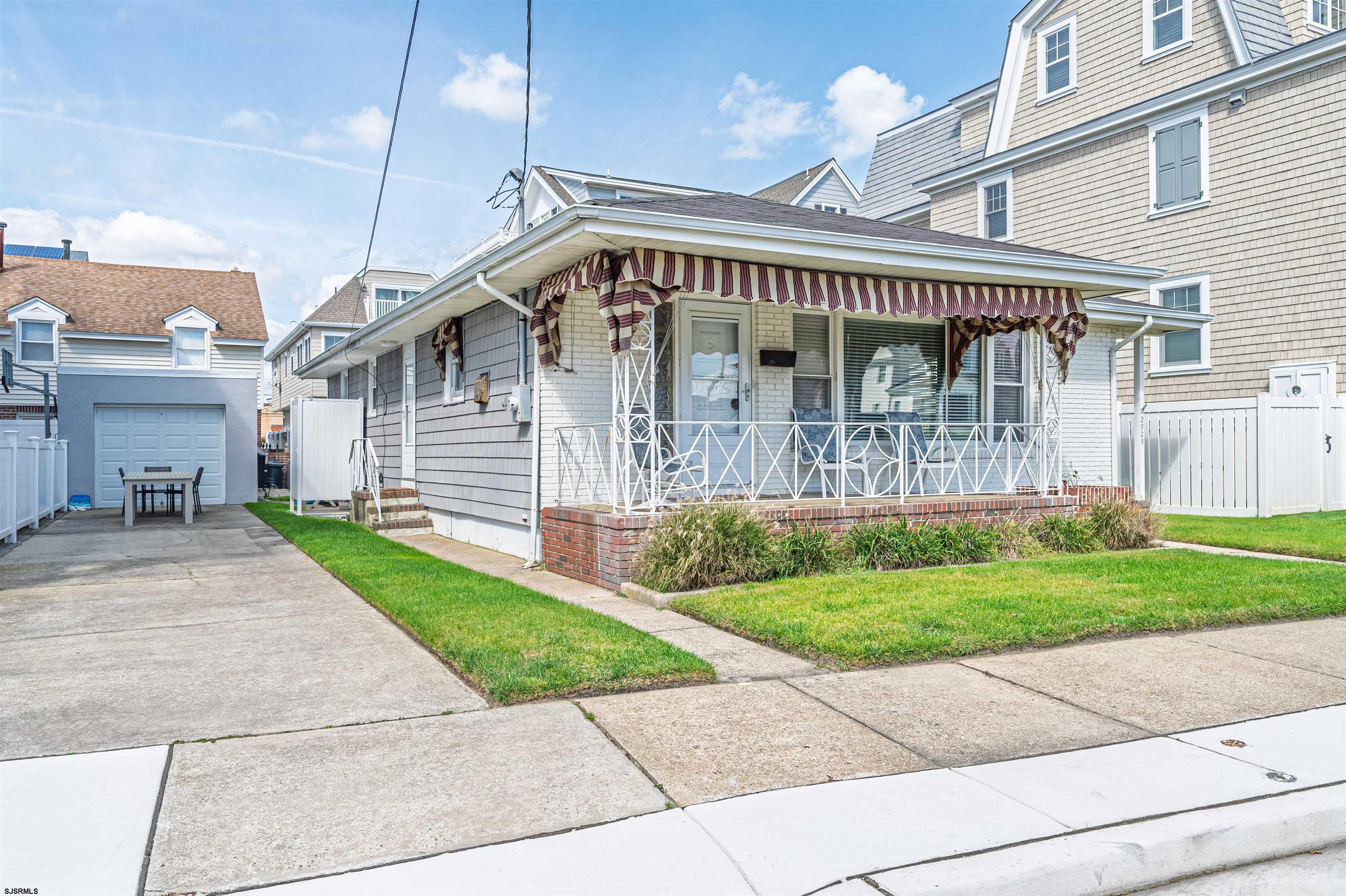 2805 Atlantic Avenue, Unit IDEAL LOCATION Longport, NJ 08403 - Photo 6 of 26 a front view of a house with a garden and deck