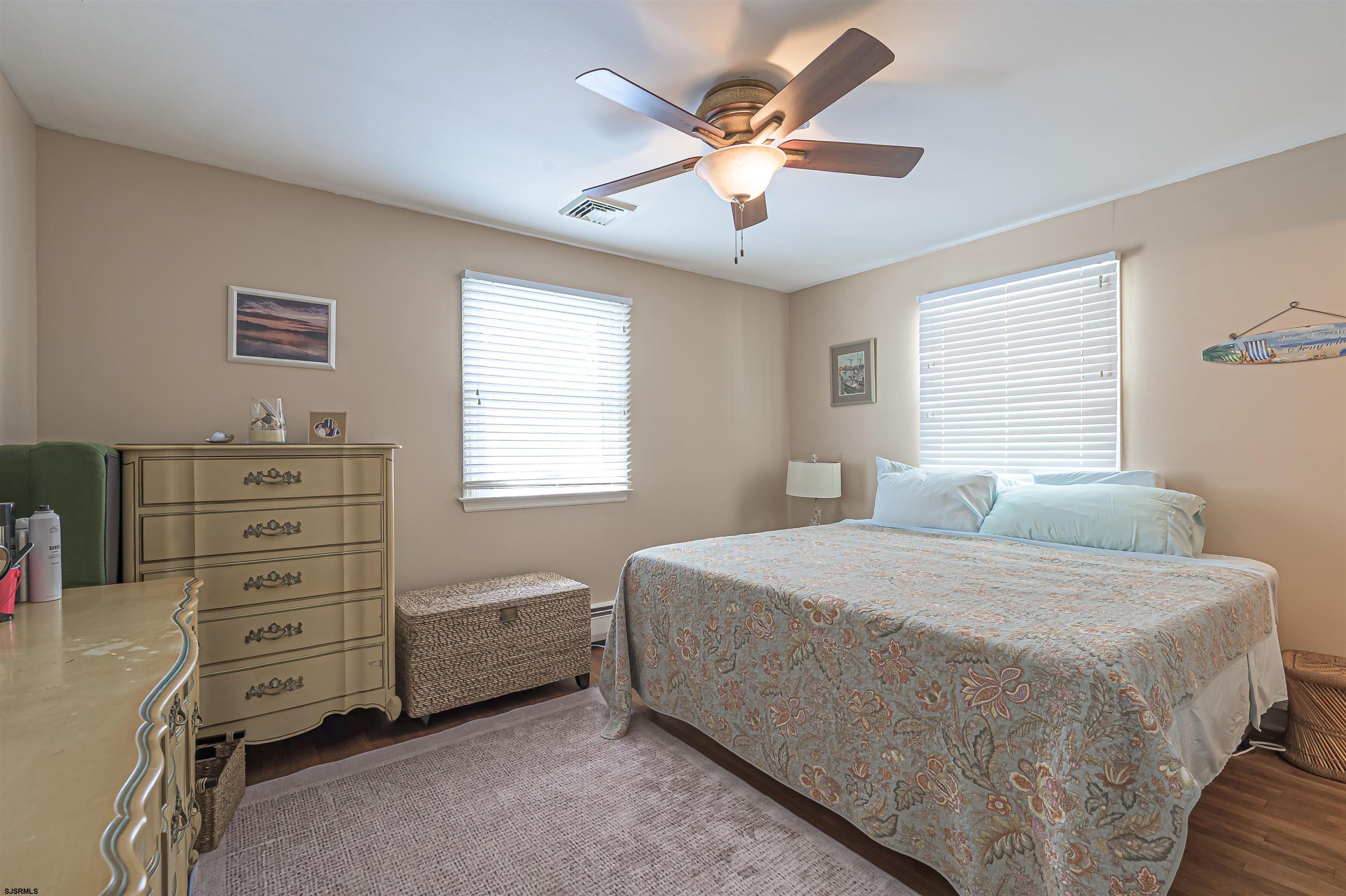 2805 Atlantic Avenue, Unit IDEAL LOCATION Longport, NJ 08403 - Photo 7 of 26 a bedroom with a bed and a window