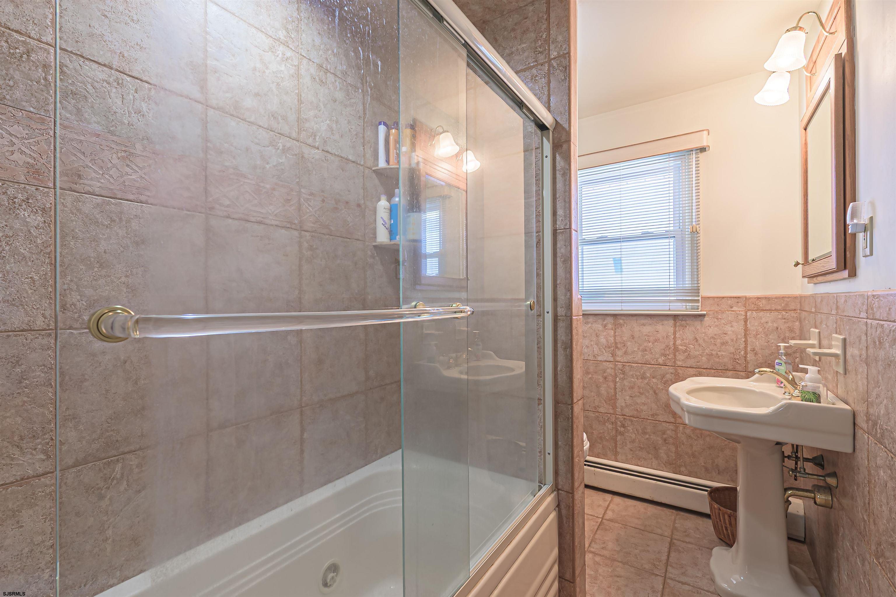 2805 Atlantic Avenue, Unit IDEAL LOCATION Longport, NJ 08403 - Photo 8 of 26 a bathroom with a sink a toilet and shower