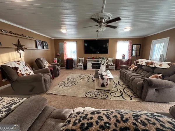 a living room with furniture and a flat screen tv
