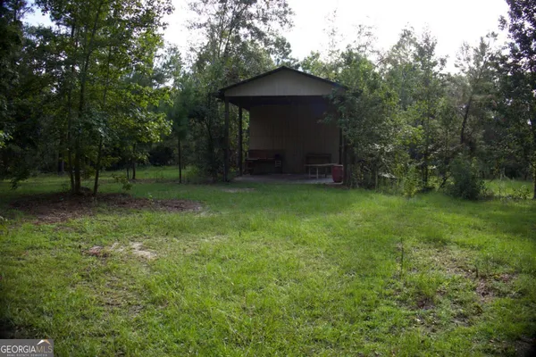 a view of a wooden deck with a yard