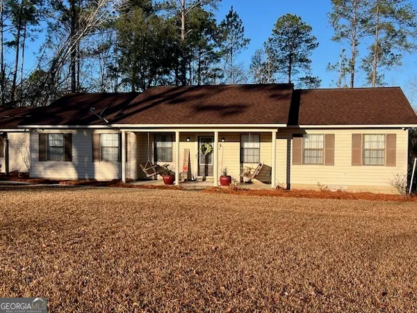 a view of a house with a backyard