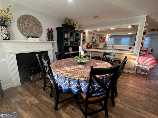 a dining room with furniture and wooden floor