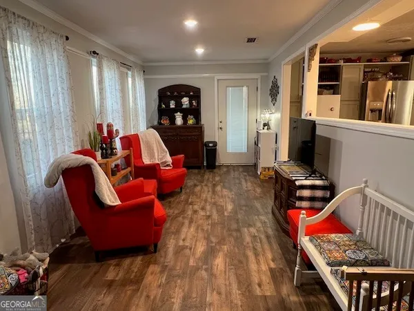 a living room with furniture a rug and a window