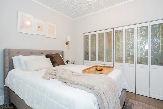 a bedroom with a bed and a large window