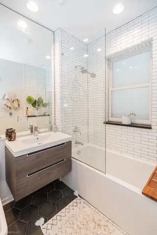 a bathroom with a bathtub and a sink