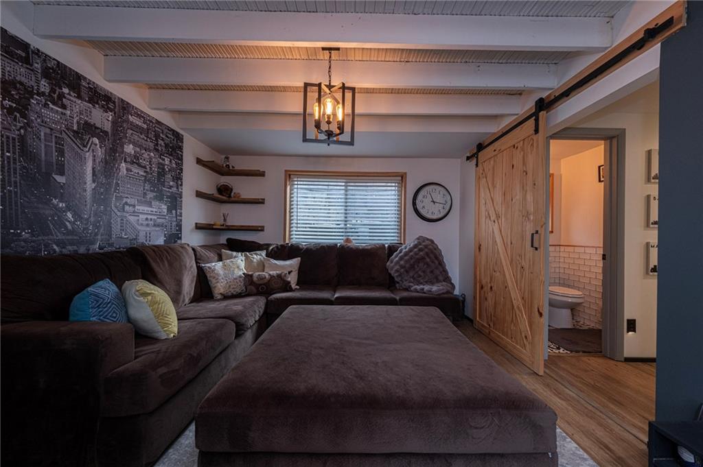 7608 Cheyenne Street Pittsburgh, PA 15218 - Photo 12 of 33 a living room with furniture and a chandelier
