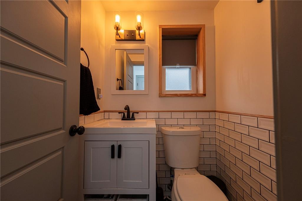 7608 Cheyenne Street Pittsburgh, PA 15218 - Photo 17 of 33 a bathroom with a toilet sink and mirror