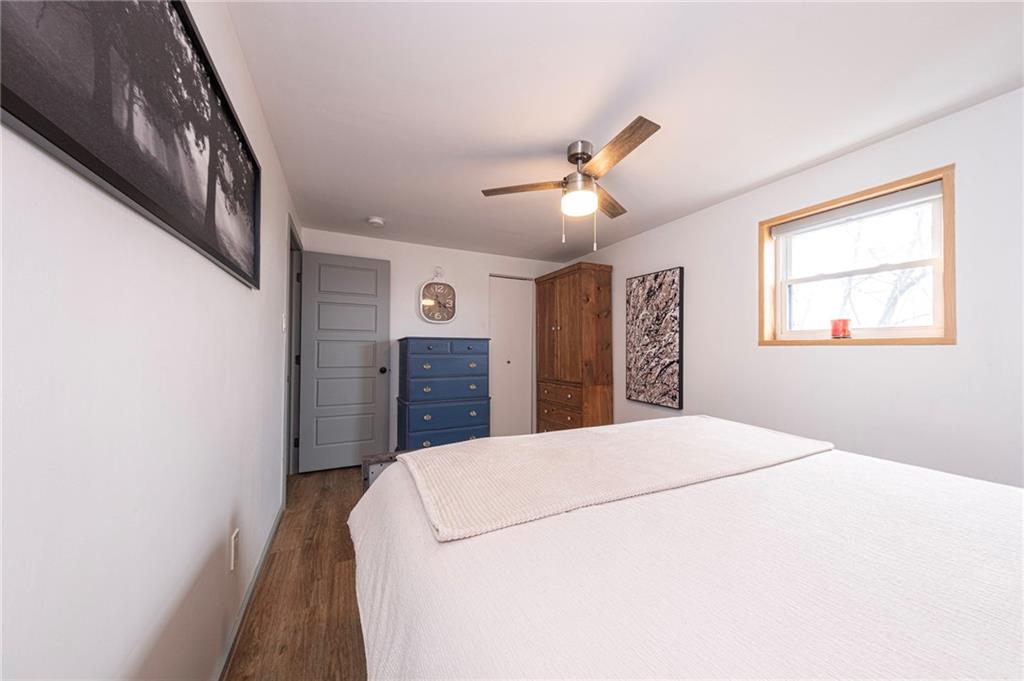 7608 Cheyenne Street Pittsburgh, PA 15218 - Photo 20 of 33 a bedroom with a large bed and a chandelier