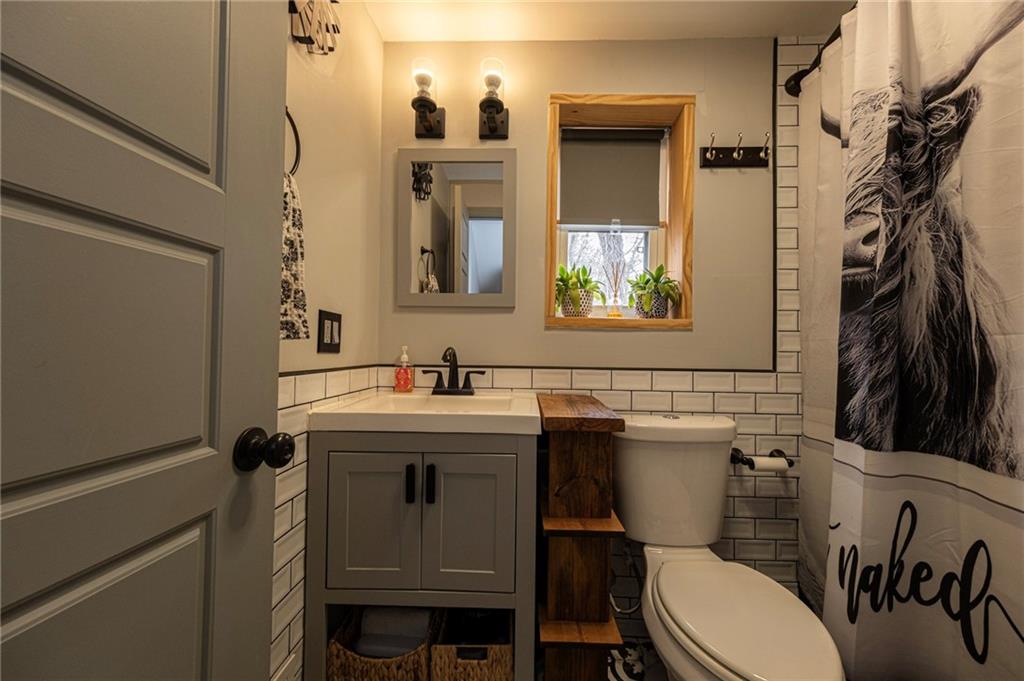 7608 Cheyenne Street Pittsburgh, PA 15218 - Photo 29 of 33 a bathroom with a sink a toilet and a mirror