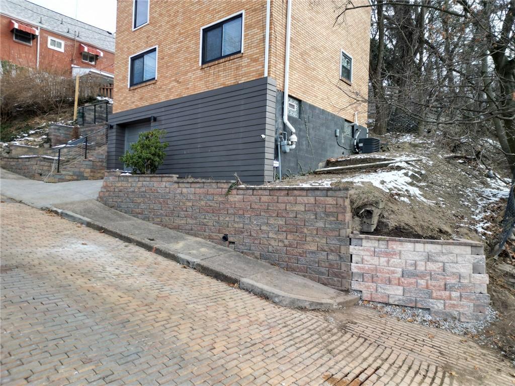 7608 Cheyenne Street Pittsburgh, PA 15218 - Photo 5 of 33 a view of a brick house with many windows