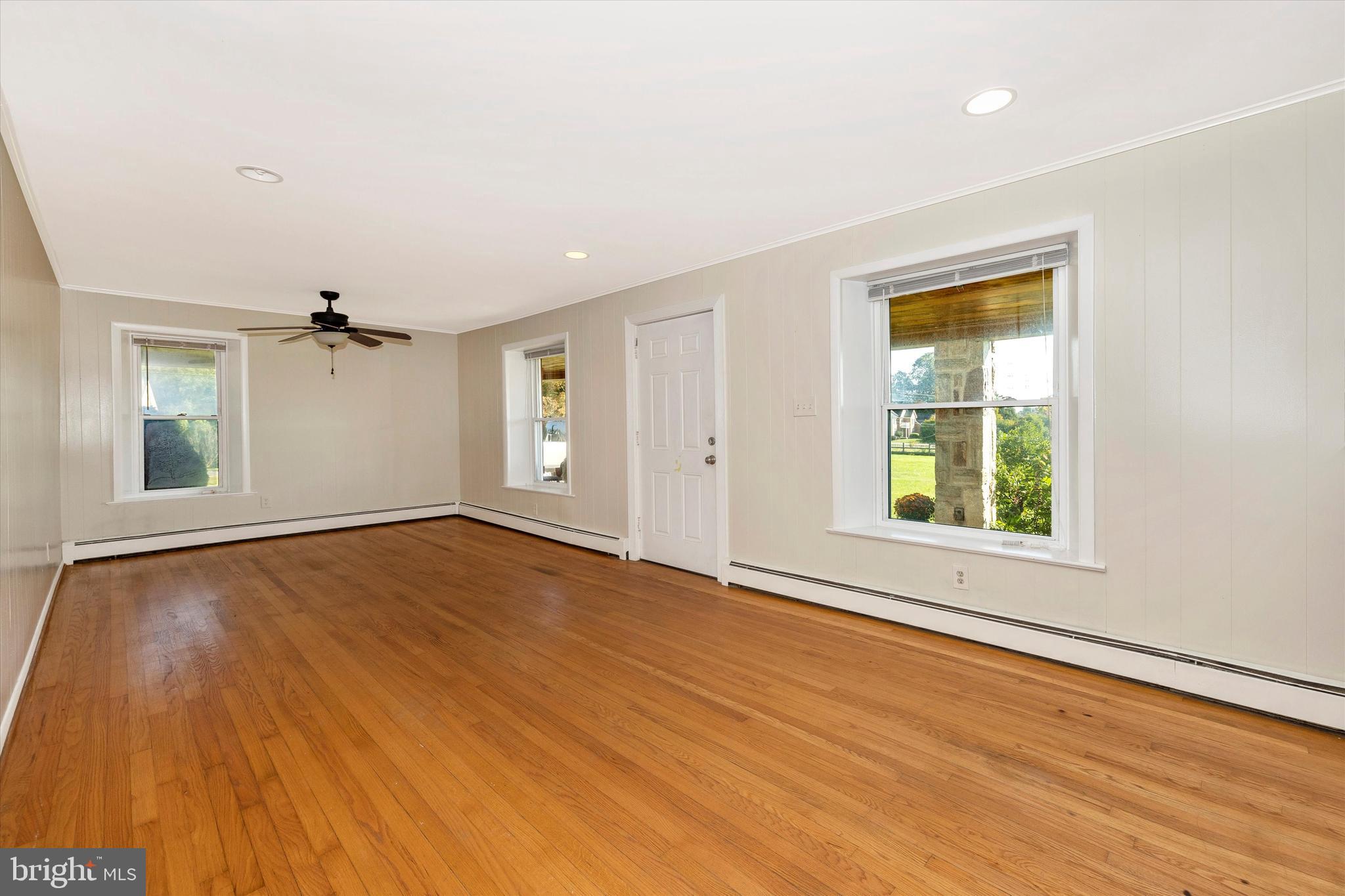 1021 Saffell Road Reisterstown, MD 21136 - Photo 29 of 57 an empty room with wooden floor cabinet and windows