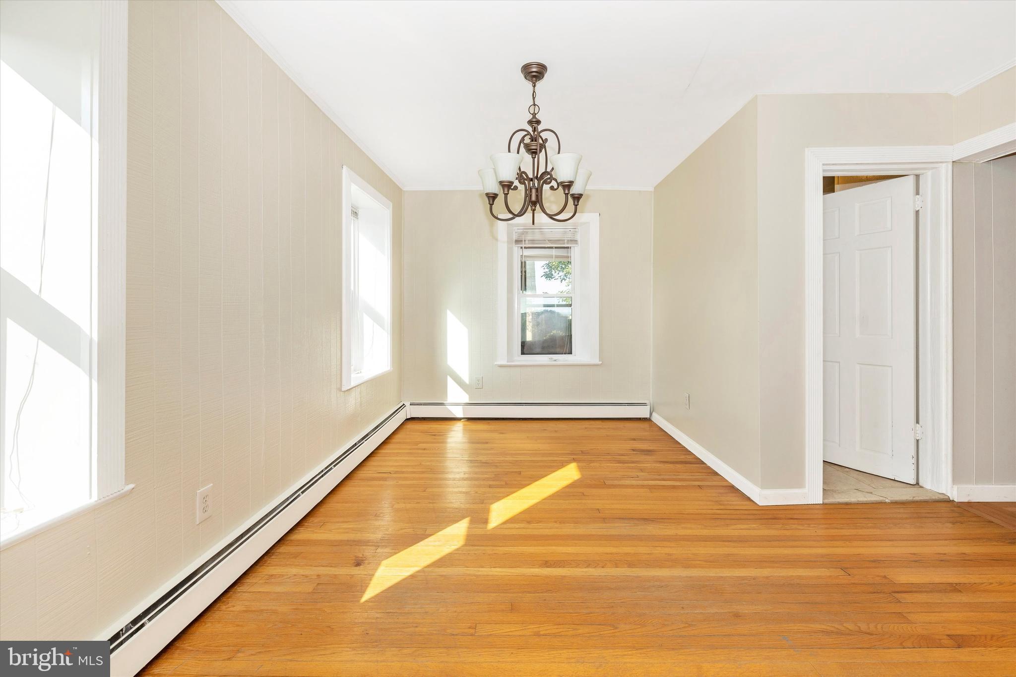 1021 Saffell Road Reisterstown, MD 21136 - Photo 32 of 57 a view of a room with wooden floor and chandelier