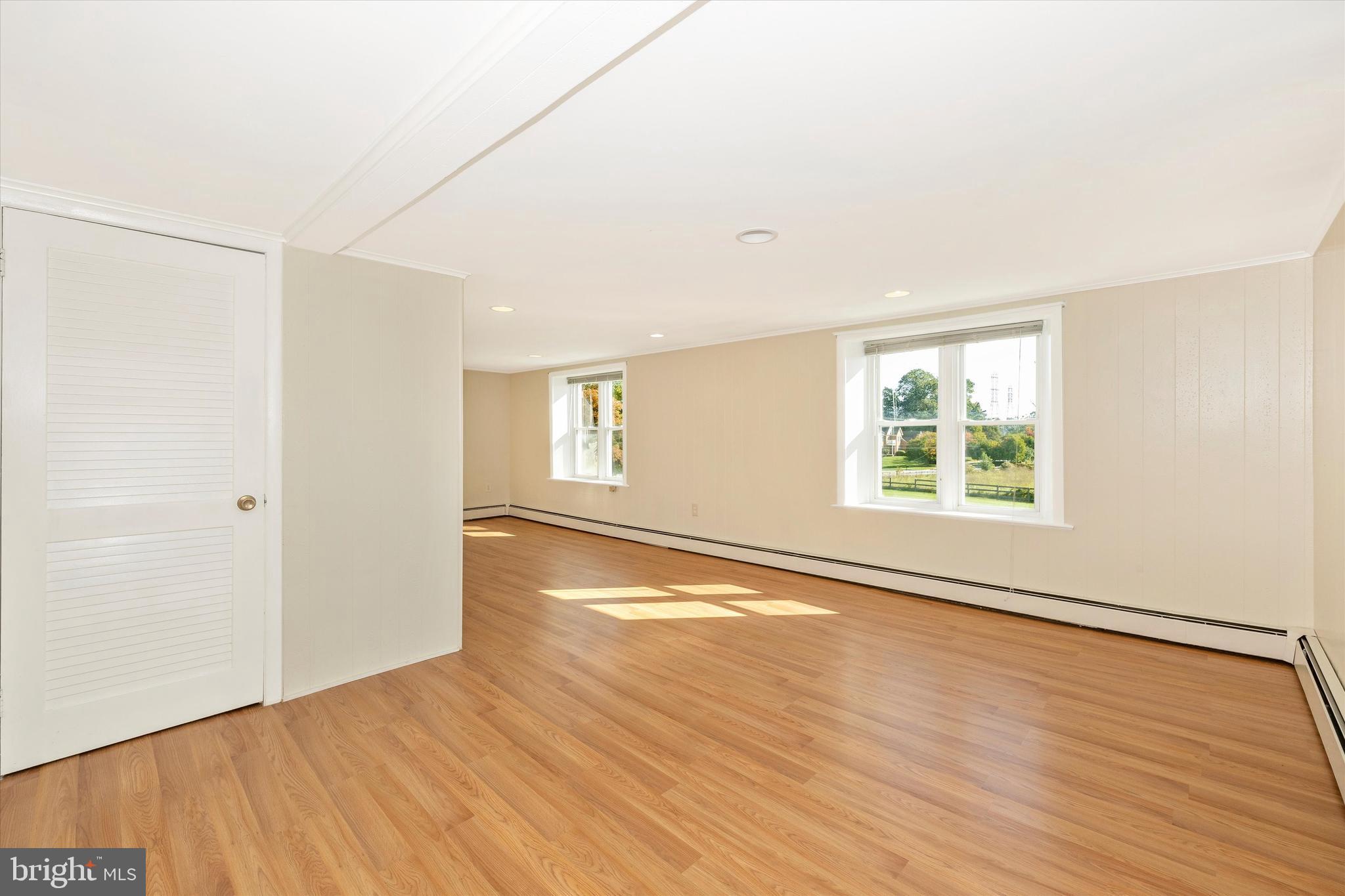 1021 Saffell Road Reisterstown, MD 21136 - Photo 50 of 57 an empty room with wooden floor and windows