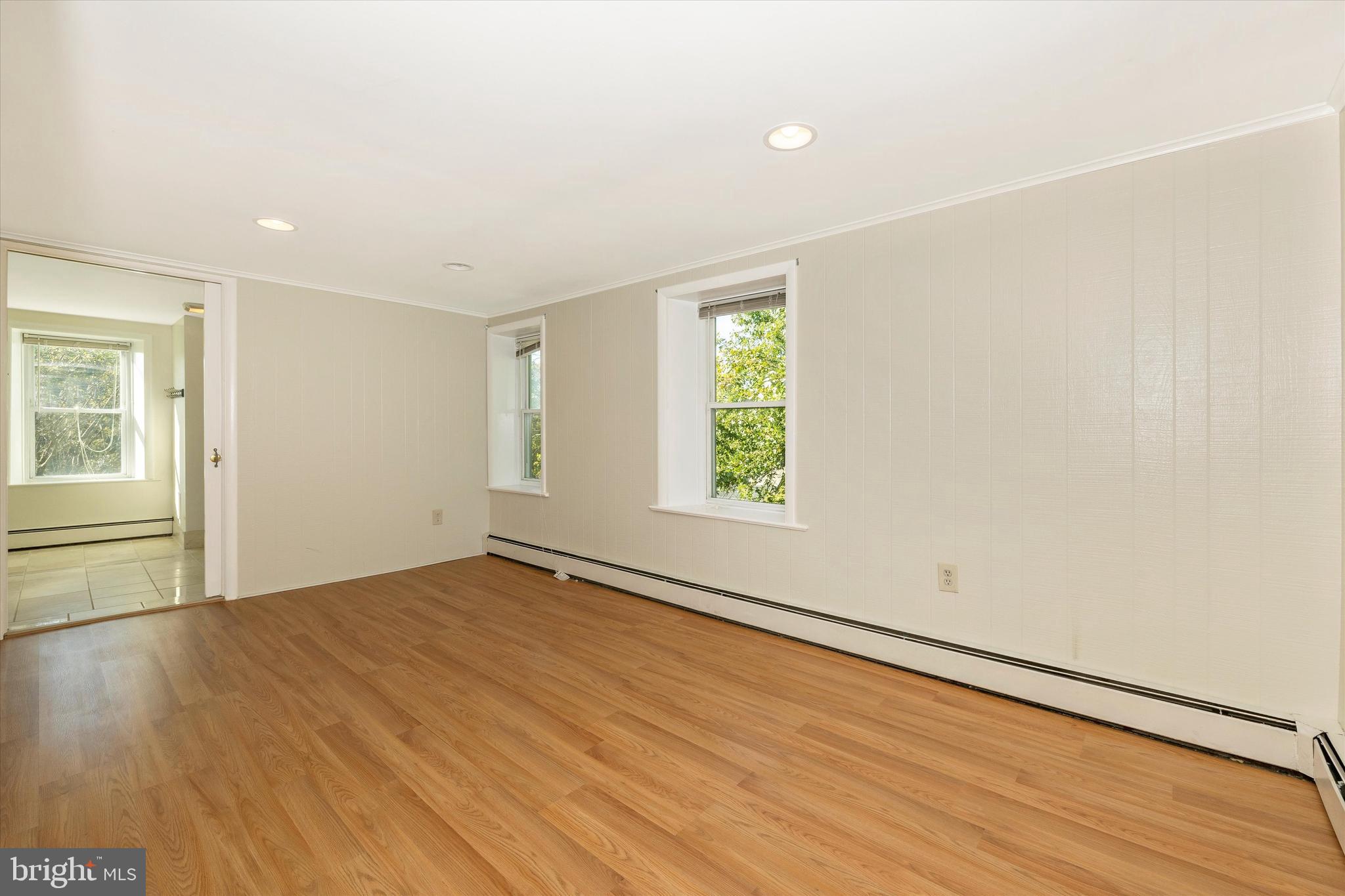 1021 Saffell Road Reisterstown, MD 21136 - Photo 52 of 57 an empty room with wooden floor and windows