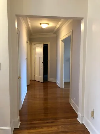 a view of a hallway with wooden floor