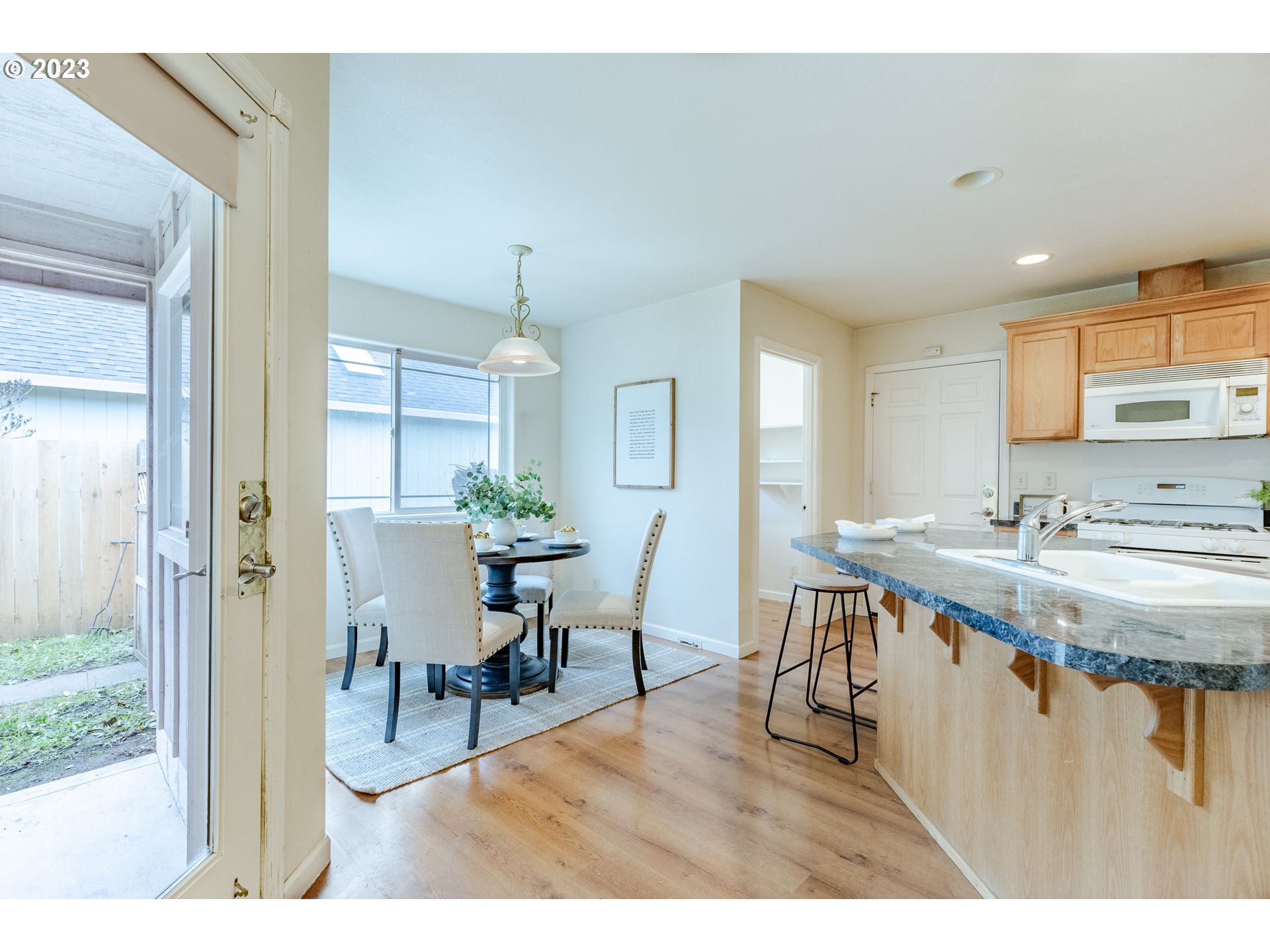 968 S Street Springfield, OR 97477 - Photo 13 of 42 a view of kitchen island dining table and chairs