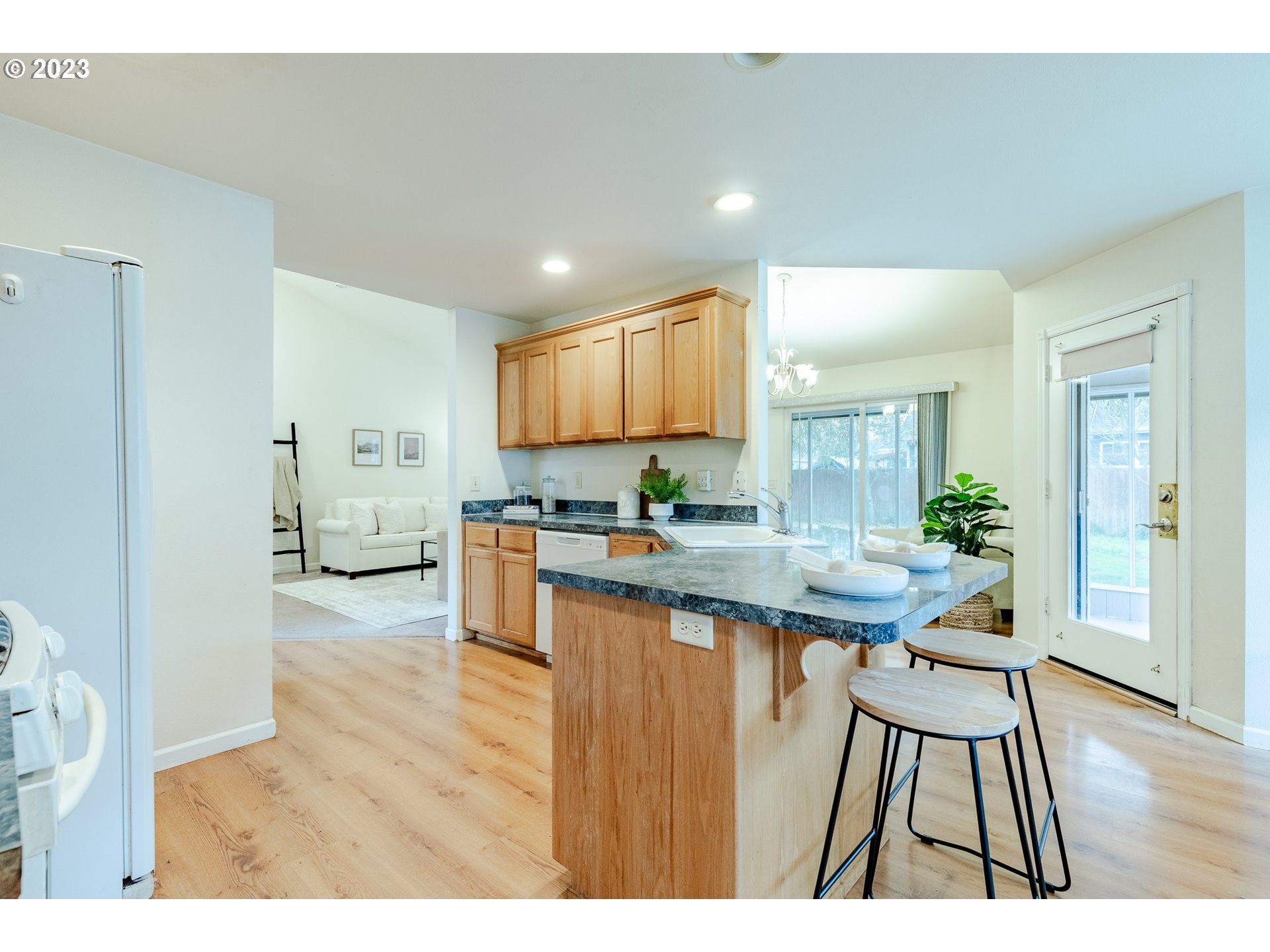 968 S Street Springfield, OR 97477 - Photo 16 of 42 a open kitchen with stainless steel appliances kitchen island a large counter space and wooden floor