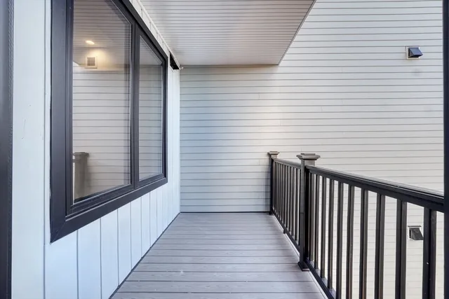 a view of a balcony with wooden floor