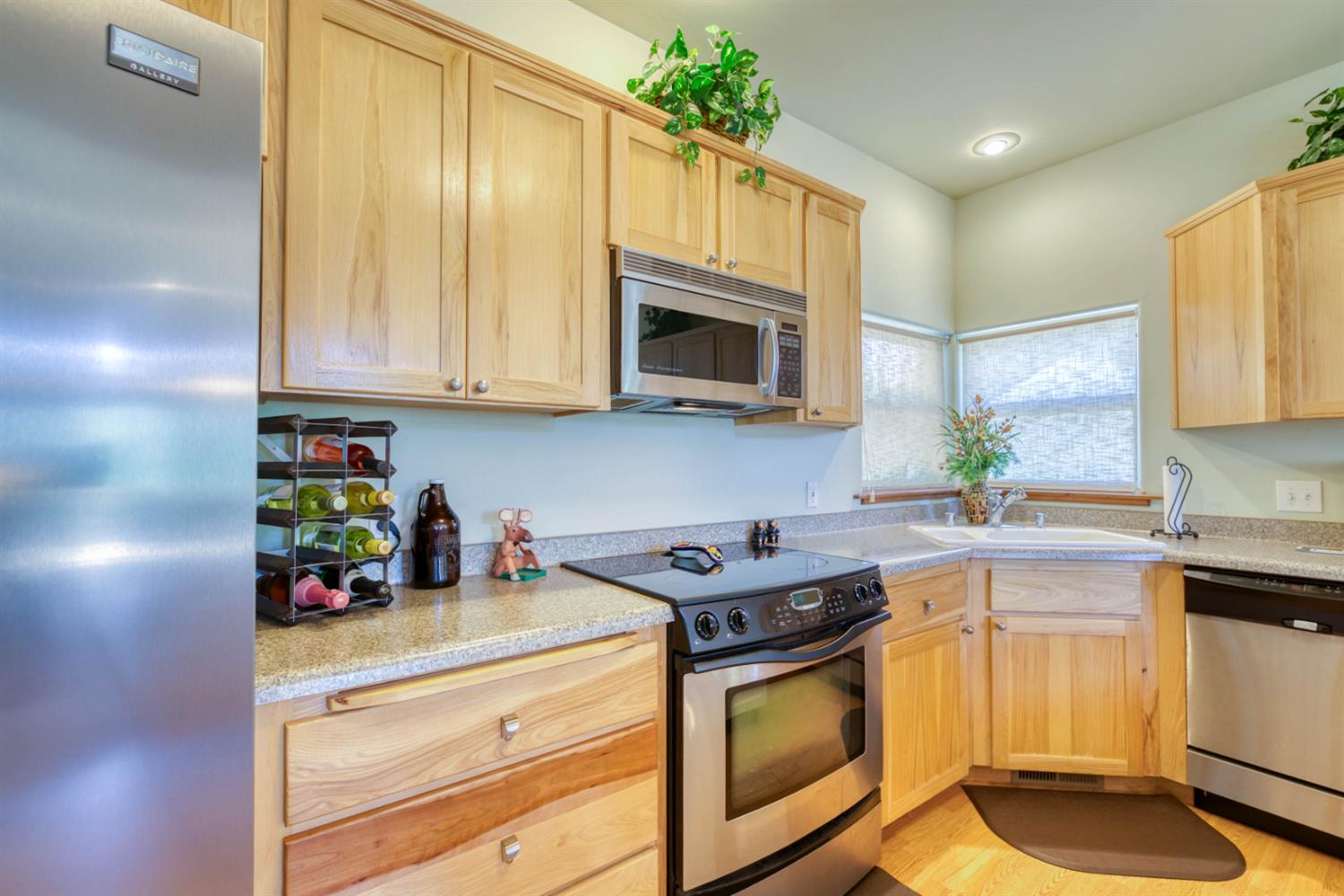 33855 Shaver Springs Road Auberry, CA 93602 - Photo 14 of 41 a kitchen with stainless steel appliances granite countertop a sink a stove a microwave a refrigerator and cabinets