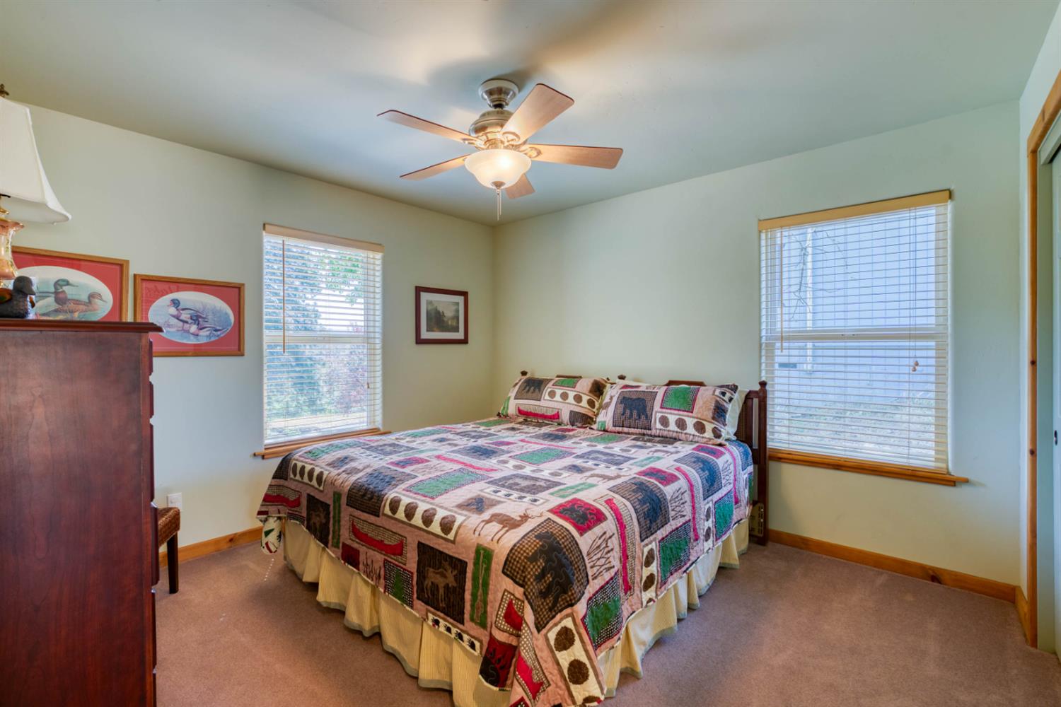 33855 Shaver Springs Road Auberry, CA 93602 - Photo 22 of 41 a bedroom with a bed and a chandelier
