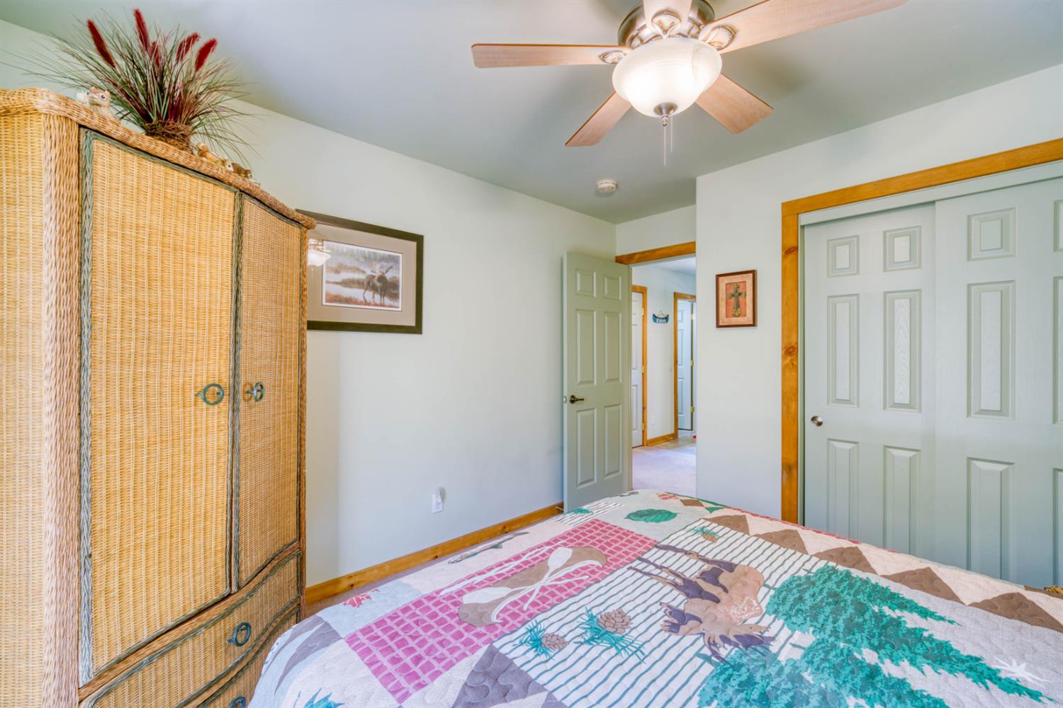 33855 Shaver Springs Road Auberry, CA 93602 - Photo 24 of 41 a bedroom with a bed and a chandelier