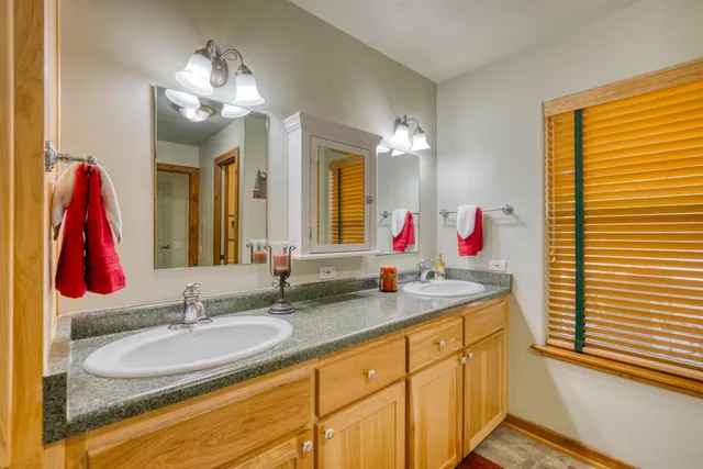 a bathroom with a sink vanity and a mirror