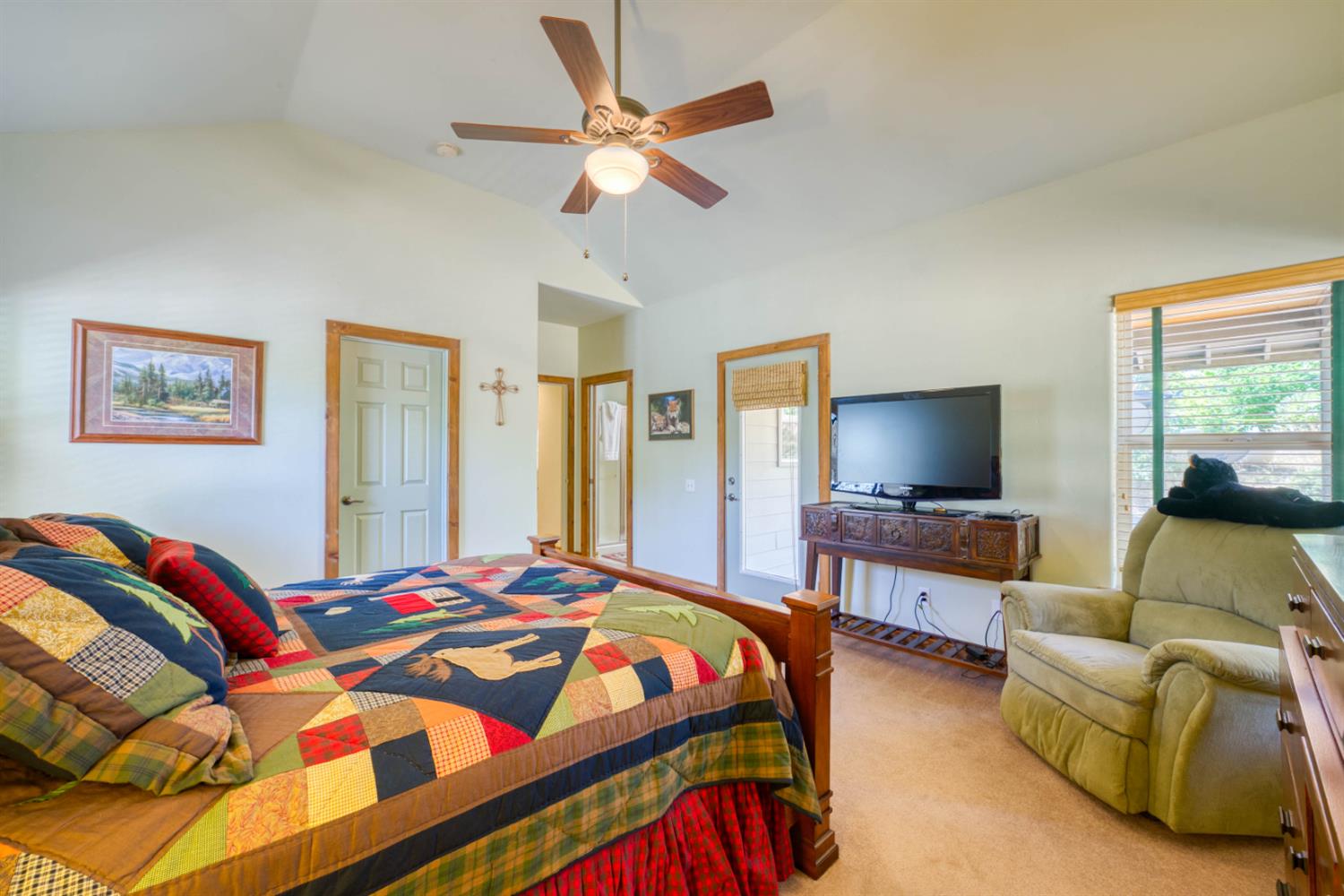 33855 Shaver Springs Road Auberry, CA 93602 - Photo 30 of 41 a bedroom with a bed a couch and a flat screen tv