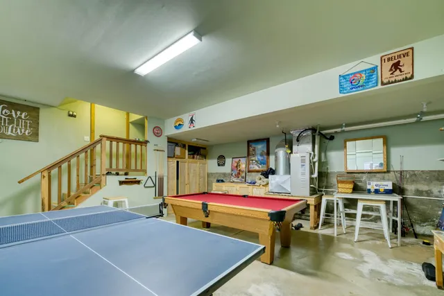 a room with furniture pool table and windows